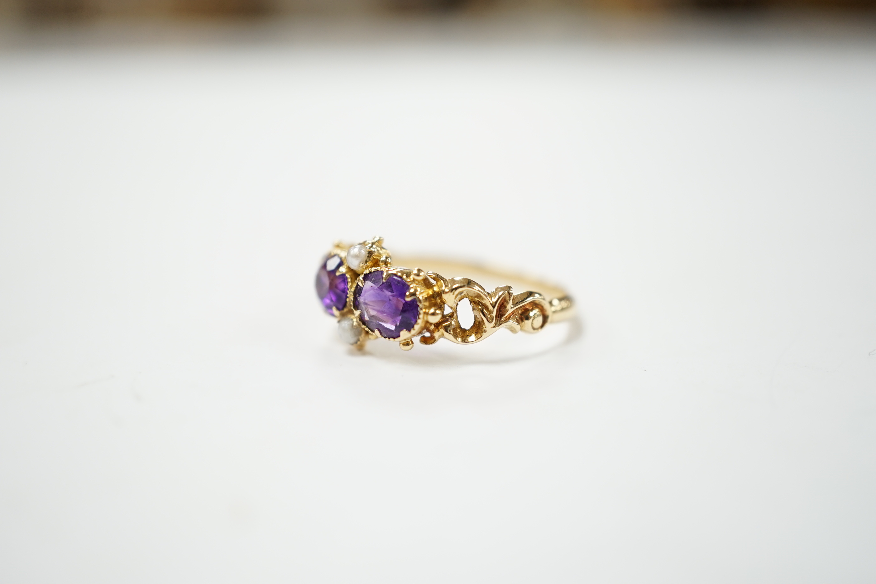 A Victorian style yellow metal, amethyst and pearl dress ring, size L